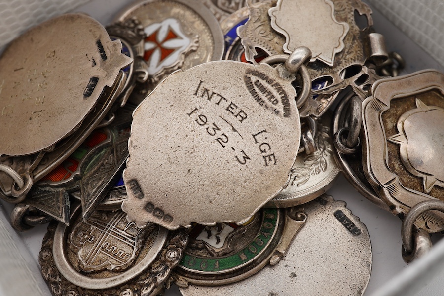 A group of twenty one assorted early 20th century silver and enamel award medals, mostly sporting. Condition - poor to fair